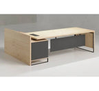 L-shape desk with light wood frame, dark side panel, and small built-in drawer