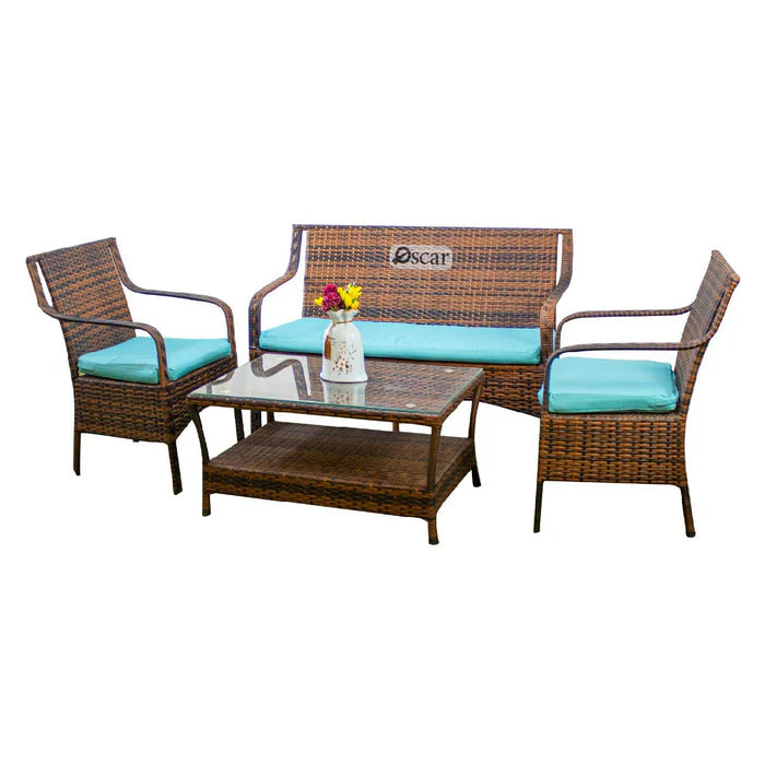 Rattan patio seating set with teal cushions, two chairs, loveseat, coffee table, bench