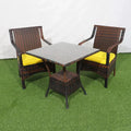 Outdoor dining set with dark wicker chairs, yellow cushions, and gray square table