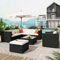 Outdoor furniture set (5 pieces) with dark woven sofa, white cushions, glass-top table