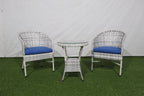 Outdoor bistro set: two wicker chairs with blue seat cushions and round glass-top table