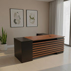 L-shaped desk in dark brown/black with drawer fronts and open corner leg