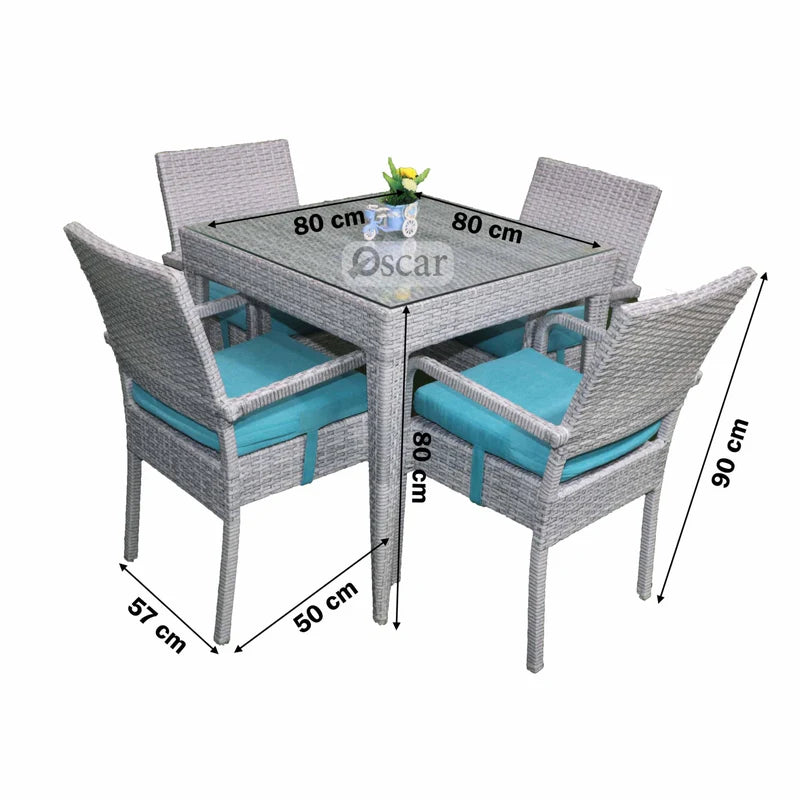 Outdoor rattan dining set for four: gray frame, glass table, turquoise cushions