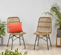 Set of 2 beige rattan cafe chairs, black metal legs, with orange seat cushions