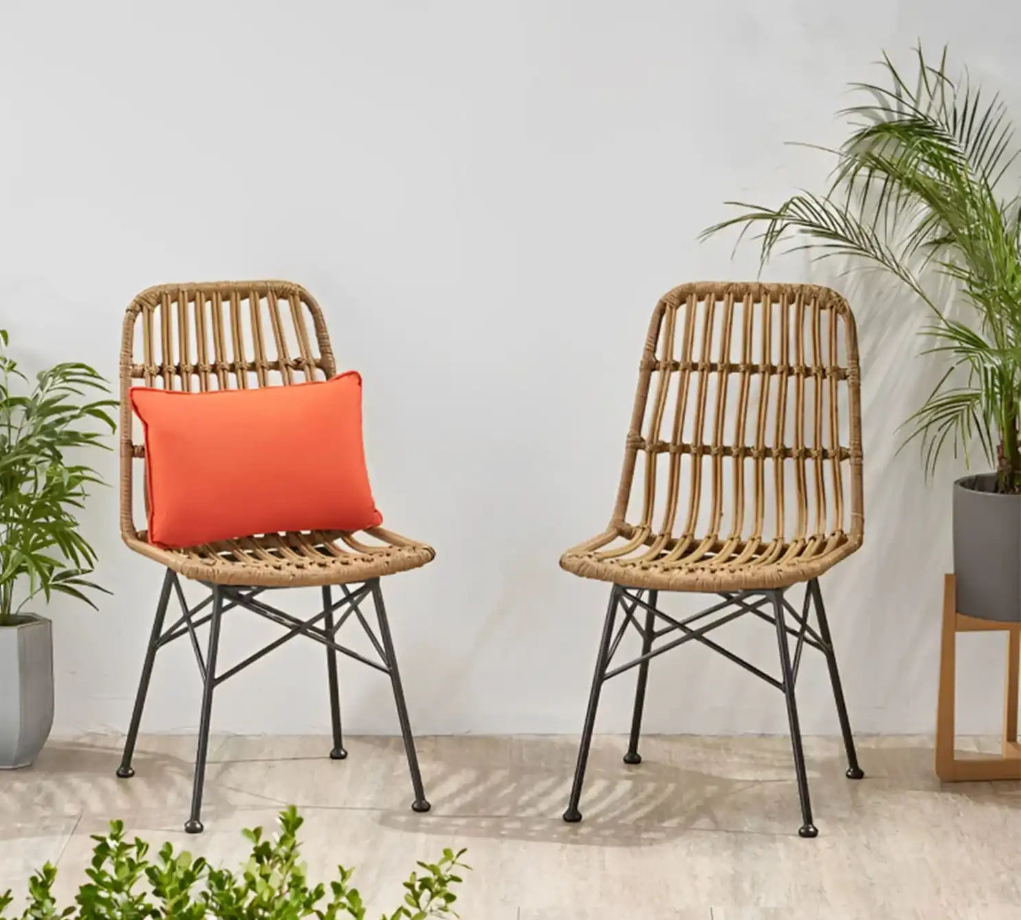 Set of 2 beige rattan cafe chairs, black metal legs, with orange seat cushions