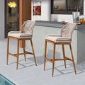 Woven bar stool with beige seat cushion and curved back, light wood frame
