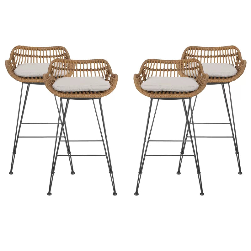 Two rattan bar chairs with oval woven seats, white cushions, black metal legs