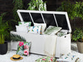 White poly rattan storage box with open hinged lid and black liner