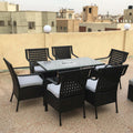 Marvel rattan dining set for 6 with black woven chairs and clear glass table, seat cushions