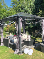 Outdoor 3-piece wicker seating set with gray cushions and coffee table on patio