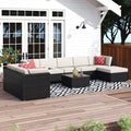 5-piece outdoor patio seating set with dark wicker frames, cream cushions, and square glass table