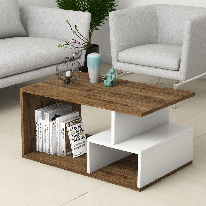 Wooden coffee table with books and decor items in a living room setting