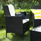 Outdoor patio furniture set: black woven chairs with white cushions and side table