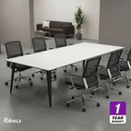 Meeting table with white top and dark legs, set with office chairs