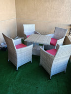 Rattan dining set for four: square table with four chairs and pink cushion upholstery
