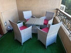 Outdoor rattan dining set with square table and four armchairs, pink cushions