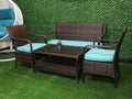 Rattan patio loveseat with teal seat cushions and two matching chairs, coffee table