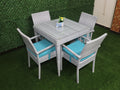 Outdoor rattan dining set for four with square gray table and turquoise seat cushions