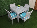 Outdoor rattan dining set for four with square gray table and turquoise seat cushions