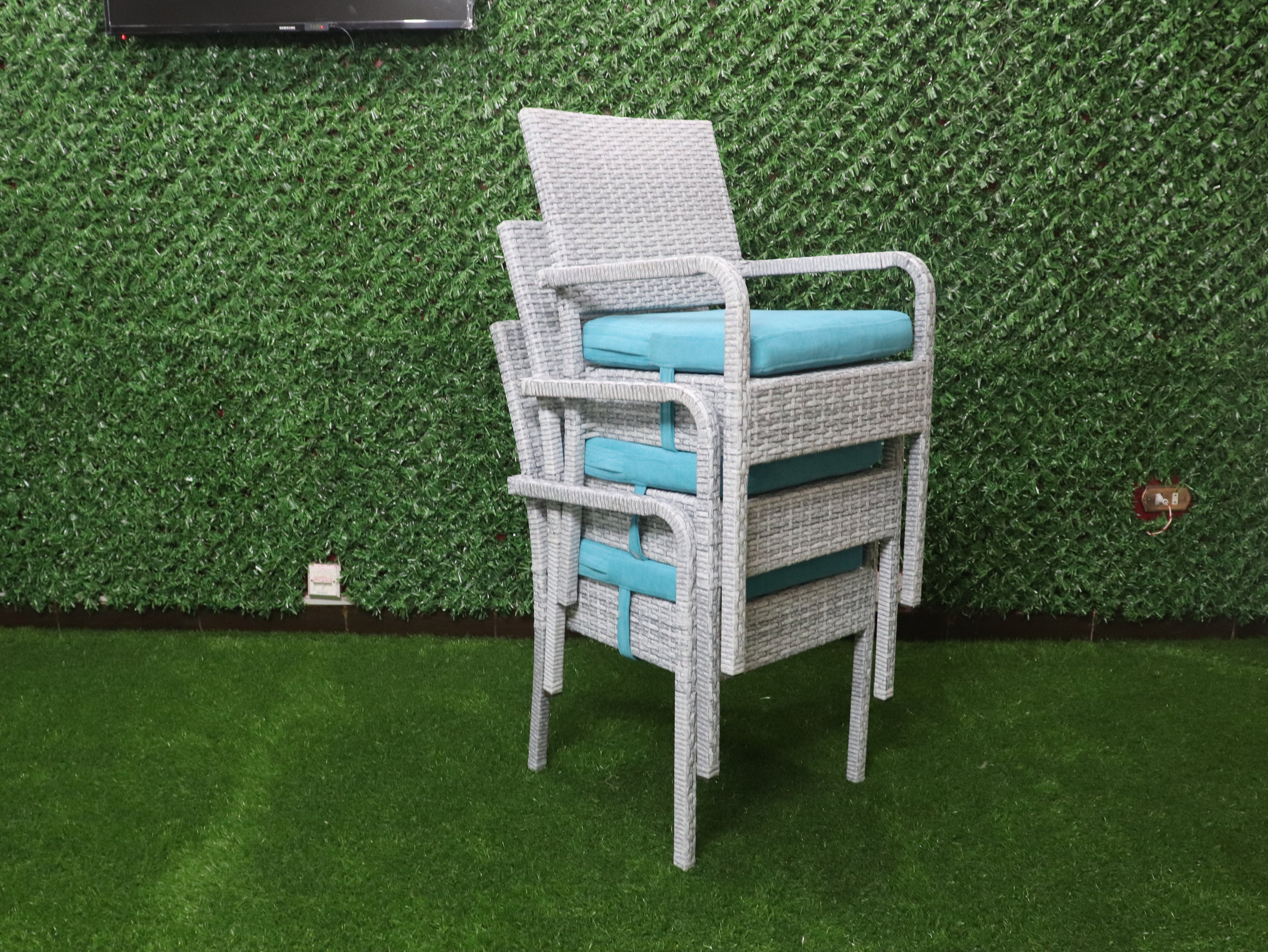 Rattan dining chair with gray woven frame and turquoise seat cushion