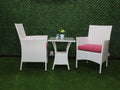 White outdoor bistro set: two armchairs with red cushions and a glass-top table