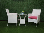 White outdoor bistro set: two armchairs with red cushions and a glass-top table