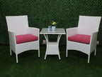 Outdoor seating set with two white armchairs, red seat cushions, and small glass table