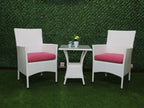 Outdoor conversation set with two white armchairs and red cushions around a glass-top table