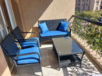 Rattan balcony seating set with blue cushions, loveseat, two chairs, coffee table