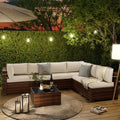 Outdoor patio corner sectional with white cushions, dark brown wicker, and square coffee table