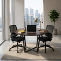 Round meeting table with dark wood tabletop and central pedestal base