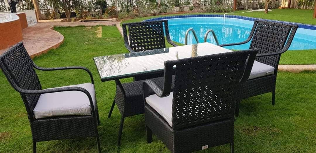 Marvel rattan dining set for 6 with black woven chairs, clear glass table, white seat cushions